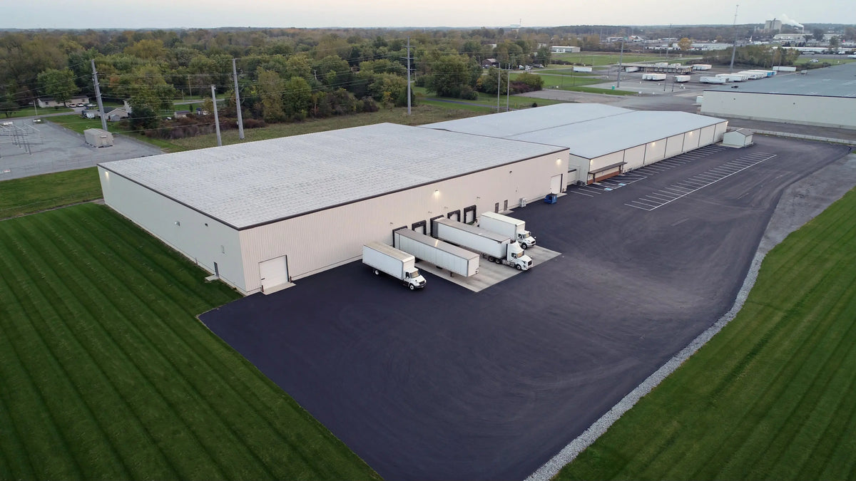 Cameron Packaging building with multiple trucks parked outside