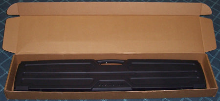 Black gun case in an open cardboard box 
