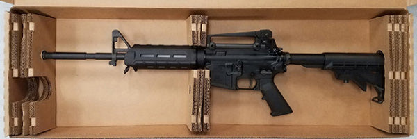 Black rifle in a cardboard box 