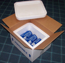 Open insulated box with blue cans of Pepsi on a checkered surface