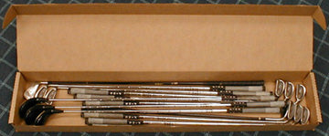 Set of golf clubs in a cardboard box 