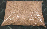 Bag of brown rubber bands on a green background