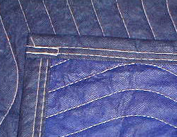 Close-up of blue blanket with stitching details